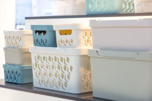 Plastic containers on a shelf on a rack for organizing home space